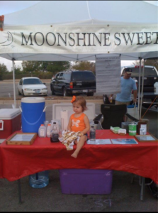 Livi, Joele's daughter, at the Moonshine Sweet Tea booth in Lakeline.